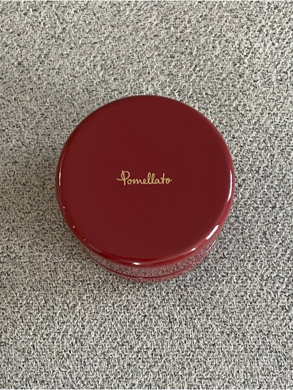 Pomellato deep red round jewelry case with gold logo
